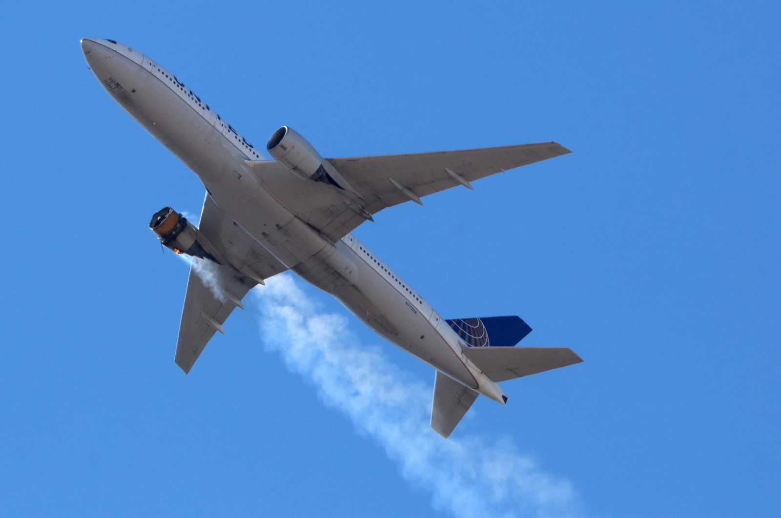 United Airlines flight UA328, carrying 231 passengers and 10 crew on board, returns to Denver International Airport with its starboard engine on fire after it sent a Mayday alert, over Denver, Colorado, U.S., Feb. 20, 2021. (Reuters Photo) 